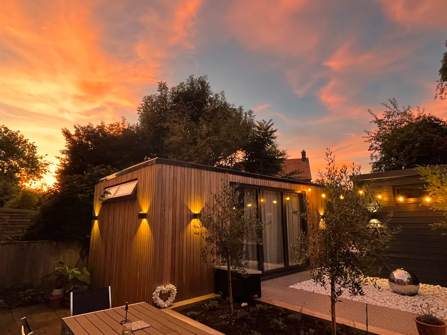 The garden studio in Twyford lit warmly at dusk